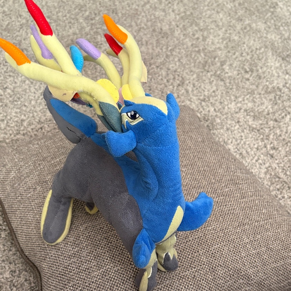 Xerneas Pokémon plush doll, specifically from the Pokémon Center
